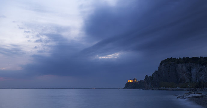  The Duino castle at blue hour from Porto Piccolo's beach in Sistiana, Trieste, Italy