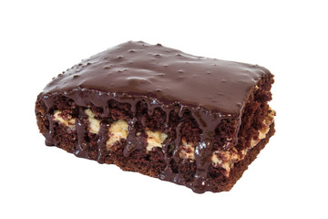 Piece of chocolate cake with icing on white isolated background