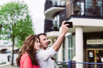 Couple taking a selfie in the city at the river
