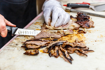 Chef slicing grilled beef steak
