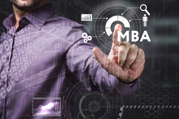 Business, Technology, Internet and network concept. Young businessman working on a virtual screen of the future and sees the inscription: MBA