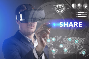 Business, Technology, Internet and network concept. Young businessman working in virtual reality glasses sees the inscription: Share
