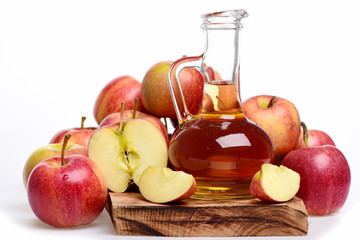 apple juice in glass bottle with fresh fruit on wood