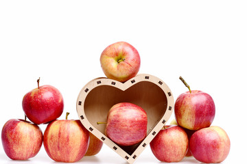 apple fruit red color in wooden box in shape of heart