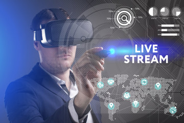 Business, Technology, Internet and network concept. Young businessman working in virtual reality glasses sees the inscription: Live stream