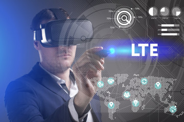 Business, Technology, Internet and network concept. Young businessman working in virtual reality glasses sees the inscription: LTE
