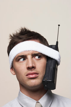 Young man with retro mobile phone