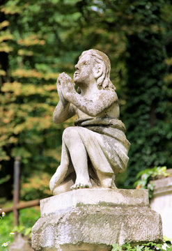 Statue of a praying angel on the cemetery