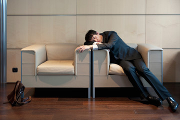 Chinese businessman sleeping in office