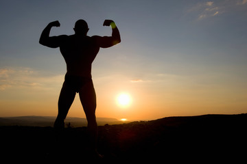 Bodybuilder Poses at Sunset.