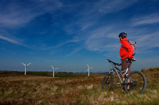 Mountain biker at a wind farm.