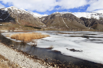 view of frozen mountain lake