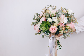 Beautiful bouquet in the hands of a florist - obrazy, fototapety, plakaty