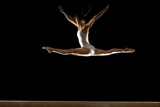 gymnast jumping on beam