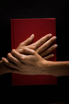 Hands holding book