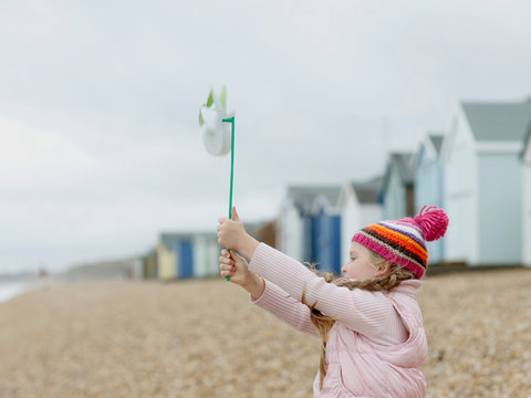 young Girl with Windmill on Beach