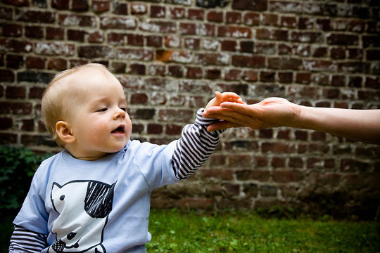 baby touches hand