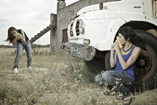 two girls play with guns