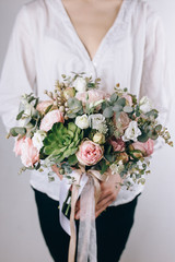 Florist at work. Make rich bouquet diferent color and flowers. Bunch in their hands