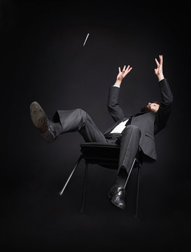 Man falling off a chair