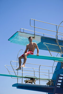 Man sitting on a spring board