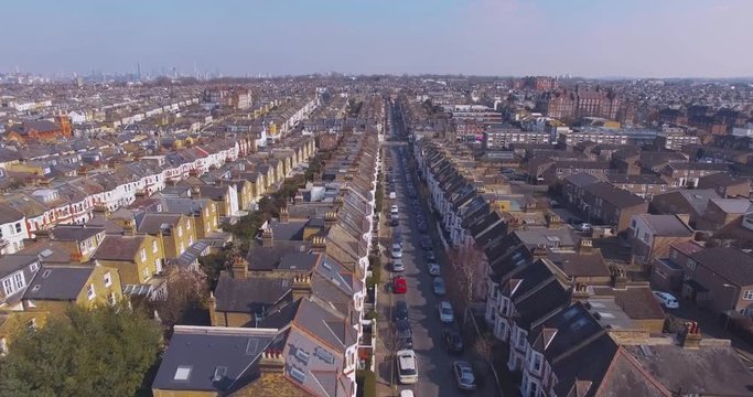 Flying Above London Surburban Houses And Apartments Aerial View At Dawn On Sunny Day