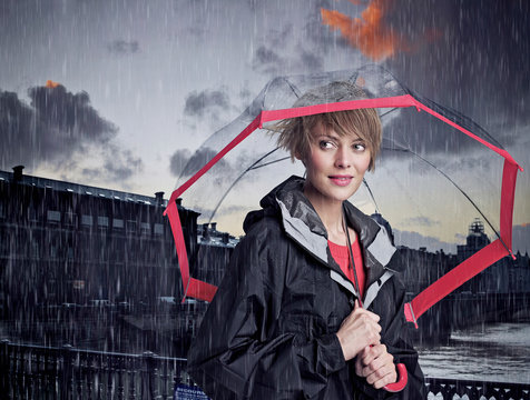 Woman walking under umbrella in rain