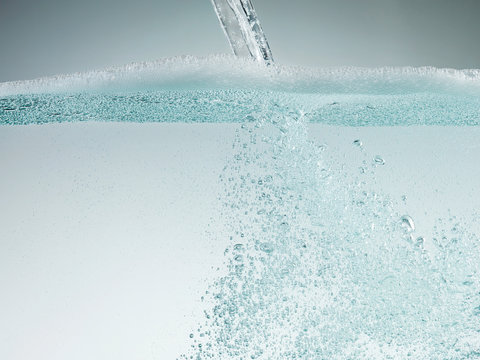 Stream pouring into soapy water