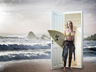 Woman emerging from door on beach