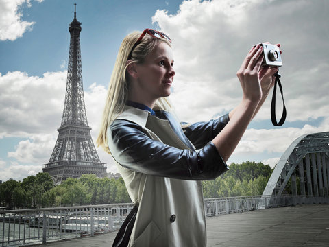 Woman taking pictures in Paris