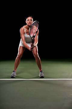 Woman playing tennis indoors