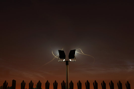 Moth trails around security light at night