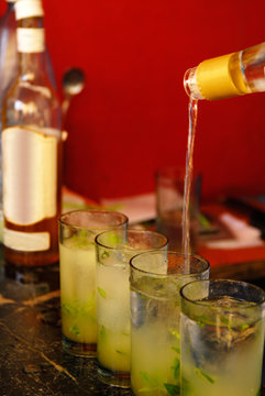 Spirit being poured into glasses