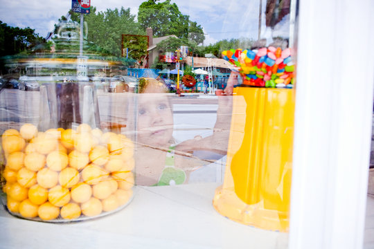 Young girl reaching for candy in candy store