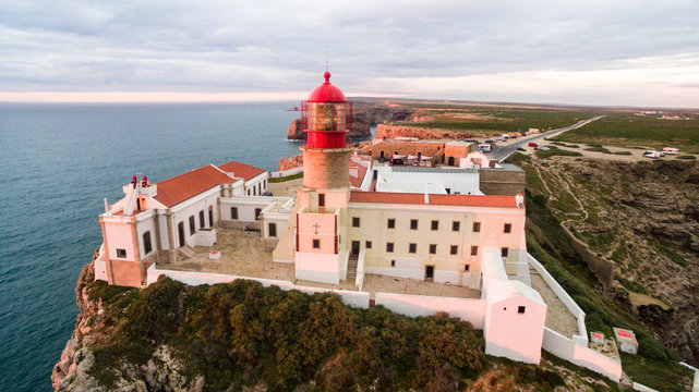 Aerial View lighthouse and cliffs at Cape St. Vincent at sunset. Europe's most South-western point, Sagres, Algarve, Portugal.