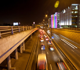 Traffic on road in urban scene at night, London, England