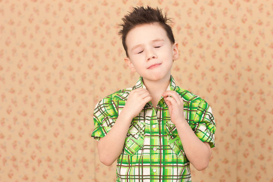 Boy buttoning collar with eyes closed