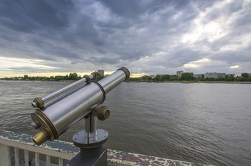 View of the Shelda River from the viewing platform of the wharf of Antwerp. Telescope with landscape