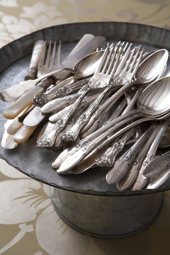 Vintage cutlery on metal tray