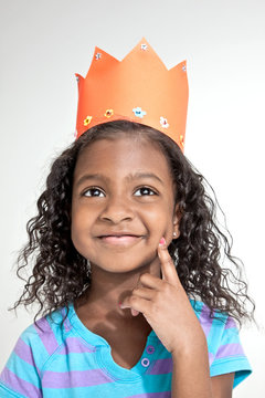 Girl wearing orange paper crown