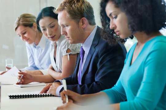Office workers sitting in a row in office