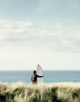Surfer looking out to sea