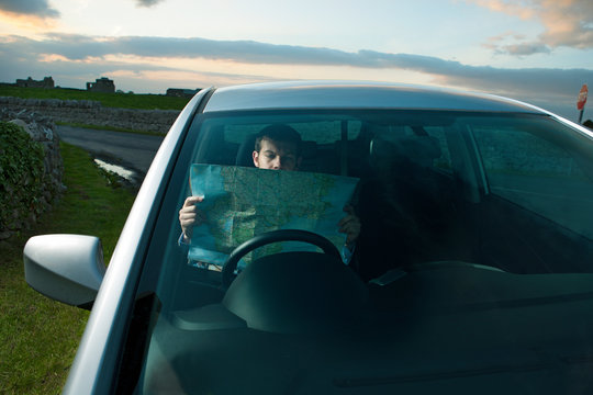 Businessman reading map in car
