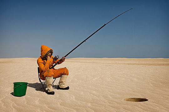 Eskimo fishing in desert