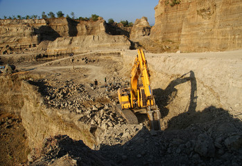 Mining construction industry. Excavator digging granite or rock in quarry