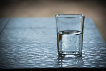 closeup Glass of water on table in the living room , vintage and retro style