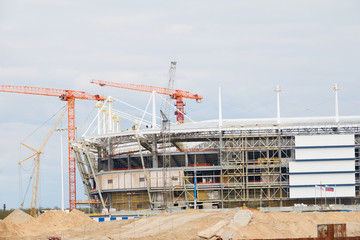 Fototapeta na wymiar Cranes at work . Stadium construction. construction of sports facilities