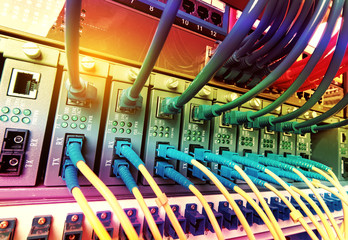 Fiber Optic cables connected to an optic ports and Network cables connected to ethernet ports
