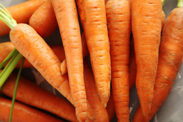 Fresh and sweet carrots on a grey table