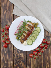 Fried chicken fillet on a wooden tables. 